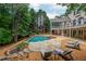Backyard featuring an in-ground pool, hot tub, and outdoor lounge area at 165 Ansley Way, Roswell, GA 30075