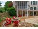 Outdoor living area with a stone fire pit, patio, and beautiful landscaping at 165 Ansley Way, Roswell, GA 30075