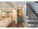 Open basement area features wet bar and staircase with wrought iron railings at 165 Ansley Way, Roswell, GA 30075
