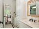 Bright bathroom features white cabinets and a view into the bedroom at 165 Ansley Way, Roswell, GA 30075