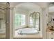 Bright soaking tub alcove with a large arched window at 165 Ansley Way, Roswell, GA 30075