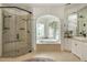 Bright bathroom with a walk-in shower and an arched soaking tub alcove at 165 Ansley Way, Roswell, GA 30075