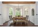 Bright dining room features large windows, hardwood floors, and an elegant chandelier at 165 Ansley Way, Roswell, GA 30075