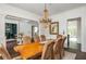 Formal dining room featuring hardwood floors, statement lighting, and seamless flow into living spaces at 165 Ansley Way, Roswell, GA 30075