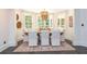 Elegant dining room with large windows, modern chandelier, and seating for six at 165 Ansley Way, Roswell, GA 30075