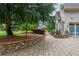 Stone paver driveway and walkway leading to the home, bordered by lush greenery and a stone retaining wall at 165 Ansley Way, Roswell, GA 30075