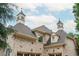 Close-up of the home's turret, showcasing architectural details like the cupola and shingle roof at 165 Ansley Way, Roswell, GA 30075