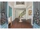 Grand foyer with hardwood floors, a staircase with iron railings, and a view of the upper level at 165 Ansley Way, Roswell, GA 30075