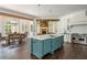 Gourmet kitchen featuring a large island, dining area, and modern appliances for seamless entertaining at 165 Ansley Way, Roswell, GA 30075