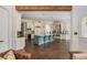 Open kitchen layout with blue island, breakfast bar, and hardwood floors with easy living at 165 Ansley Way, Roswell, GA 30075