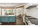 Open-concept kitchen with a large island, stainless appliances, and dining area with natural light at 165 Ansley Way, Roswell, GA 30075