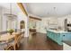 Open-concept kitchen with a large center island, stylish lighting, and seamlessly connects to the dining area at 165 Ansley Way, Roswell, GA 30075