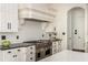 Modern kitchen with stainless steel stove, subway tile backsplash, and custom white cabinetry at 165 Ansley Way, Roswell, GA 30075