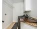Laundry room features a dark countertop and a modern washer and dryer at 165 Ansley Way, Roswell, GA 30075