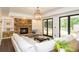 Bright living room features stone fireplace and leads to outdoor patio with a pool at 165 Ansley Way, Roswell, GA 30075