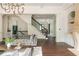 Stylish living room showcases dark hardwood floors, a staircase, and a seamless transition to other rooms at 165 Ansley Way, Roswell, GA 30075