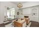 A living room with a fireplace and built-in shelves, offering a view into the main bedroom at 165 Ansley Way, Roswell, GA 30075