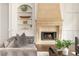 Cozy living room with a stone fireplace, built-in shelving, hardwood floors, and comfortable seating at 165 Ansley Way, Roswell, GA 30075
