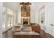 Inviting living room with vaulted ceilings, a stone fireplace, and large windows offering natural light at 165 Ansley Way, Roswell, GA 30075