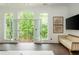 Bright main bedroom with french doors to balcony with green tree views at 165 Ansley Way, Roswell, GA 30075