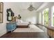 This main bedroom features white walls, dark wood floors, chandelier, and windows to balcony at 165 Ansley Way, Roswell, GA 30075