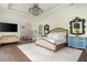 Spacious main bedroom features a chandelier, light colored walls and wood floors at 165 Ansley Way, Roswell, GA 30075
