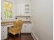 A bright office nook with granite countertops, built in cabinets, and a window to the outdoors at 165 Ansley Way, Roswell, GA 30075