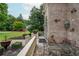 Cozy outdoor patio area with stone flooring, elegant iron furniture, and lush landscaping for privacy at 165 Ansley Way, Roswell, GA 30075