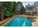 Luxurious backyard featuring a large pool, hot tub, and meticulously landscaped grounds at 165 Ansley Way, Roswell, GA 30075