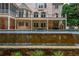 Beautiful backyard pool with a stunning waterfall feature and luxurious patio space at 165 Ansley Way, Roswell, GA 30075