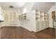 Large walk-in closet with multiple storage cabinets and hanging racks at 165 Ansley Way, Roswell, GA 30075