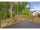 Large back deck overlooking a backyard with a green forest for outdoor relaxation and entertainment at 2545 Bertrand Way, Cumming, GA 30041
