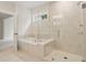 Elegant bathroom featuring a glass enclosed shower and separate soaking tub at 2545 Bertrand Way, Cumming, GA 30041