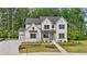 New construction two-story home with Hardie siding, gray roof and landscaped yard at 2545 Bertrand Way, Cumming, GA 30041