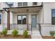 Charming covered front porch with wood columns and a light blue front door at 2545 Bertrand Way, Cumming, GA 30041