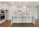 Modern kitchen with a central island, stainless steel appliances, and sleek white cabinetry at 2545 Bertrand Way, Cumming, GA 30041