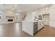 Open-concept living room and kitchen featuring a fireplace and quartz kitchen island at 2545 Bertrand Way, Cumming, GA 30041