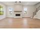 Spacious living room with hardwood floors, recessed lighting and fireplace at 2545 Bertrand Way, Cumming, GA 30041