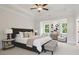 Beautiful main bedroom with tray ceiling, bench, sitting area, and bedside tables at 2545 Bertrand Way, Cumming, GA 30041
