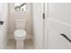 Classic powder room with white toilet and door with dark hardware at 2545 Bertrand Way, Cumming, GA 30041