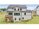 Back exterior of the home features a multi-level deck and a well-manicured lawn, perfect for outdoor living at 2545 Bertrand Way, Cumming, GA 30041