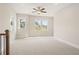 Bonus room with neutral carpet, bright windows, and a ceiling fan at 2545 Bertrand Way, Cumming, GA 30041