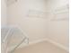 Walk-in closet featuring carpeted floor and white wire shelving for optimal storage at 2545 Bertrand Way, Cumming, GA 30041