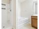 Bright bathroom with a separate shower stall, soaking tub, and neutral tile flooring, creating a spa-like atmosphere at 3335 Thornbridge Dr, Powder Springs, GA 30127