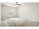 Light-filled bedroom with a ceiling fan, neutral carpeting, and a window, offering a calm and restful retreat at 3335 Thornbridge Dr, Powder Springs, GA 30127