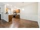Open dining area features hardwood floors, wainscoting, and modern light fixture at 3335 Thornbridge Dr, Powder Springs, GA 30127