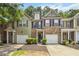 Two-story brick and vinyl townhome featuring a one-car garage and beautifully maintained landscaping at 3335 Thornbridge Dr, Powder Springs, GA 30127