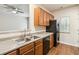 Bright kitchen features stainless steel appliances, wood cabinets and modern fixtures at 3335 Thornbridge Dr, Powder Springs, GA 30127