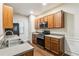 Well-lit kitchen with stainless steel appliances, wood cabinets, and hardwood floors at 3335 Thornbridge Dr, Powder Springs, GA 30127