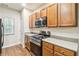 Kitchen features stainless steel microwave and gas range, with wood cabinets at 3335 Thornbridge Dr, Powder Springs, GA 30127